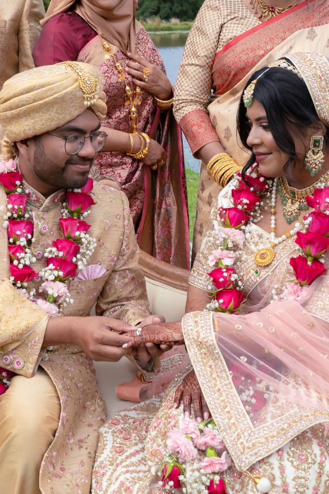 Couple exchange rings wearing traditional Bangladeshi dress