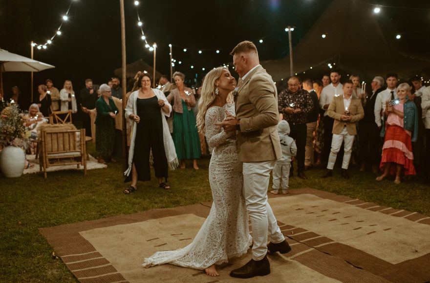 A couple dance their first dance under the stars 