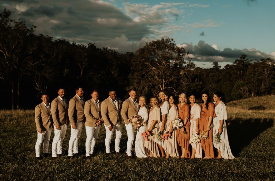 Large wedding party pose for a group photo with the national park as a backdrop