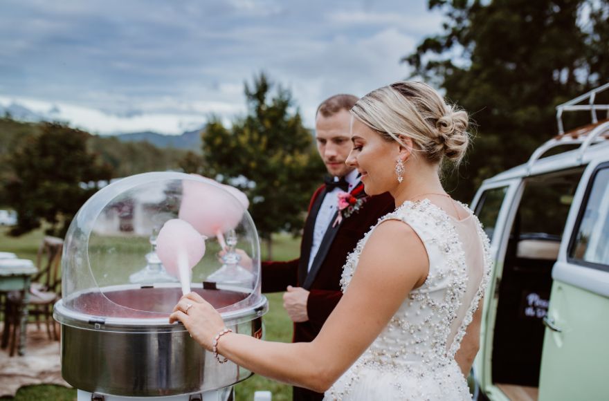 Newly wed couple enjoy fairy floss at their wedding reception