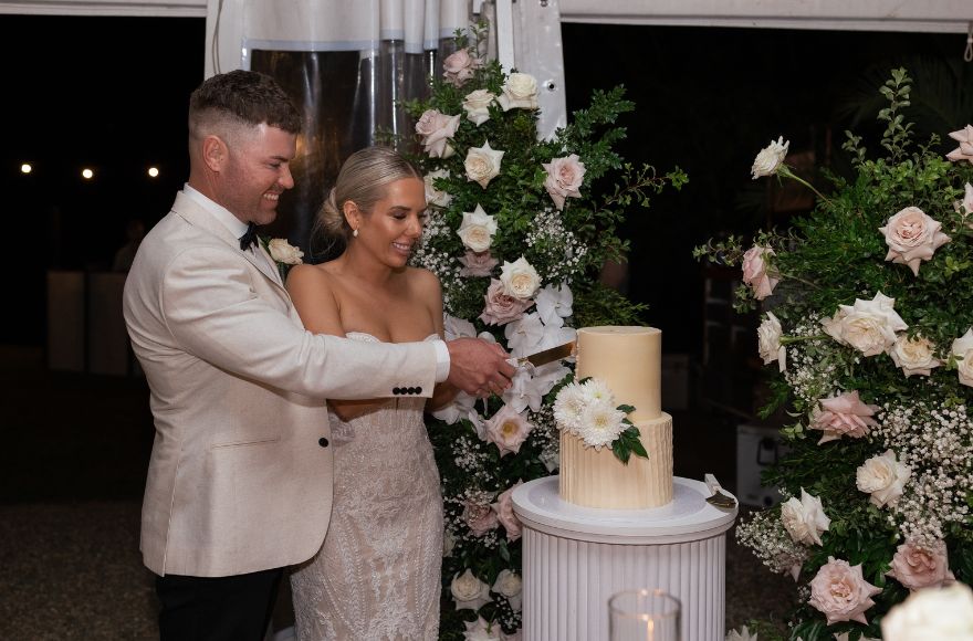 Bride and groom cut their cake at the wedding reception