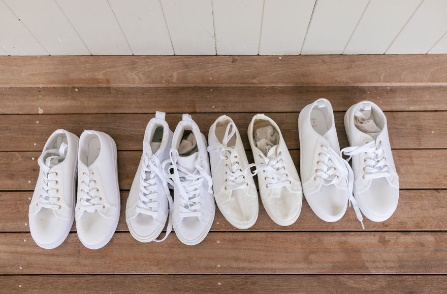 Four pairs of white sneakers ready for the bridal party.