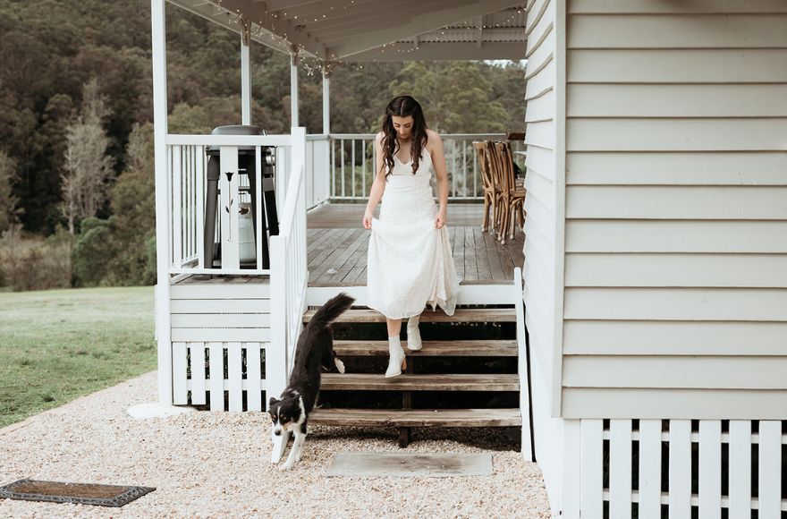 Bride wears white ankle boots with her wedding gown