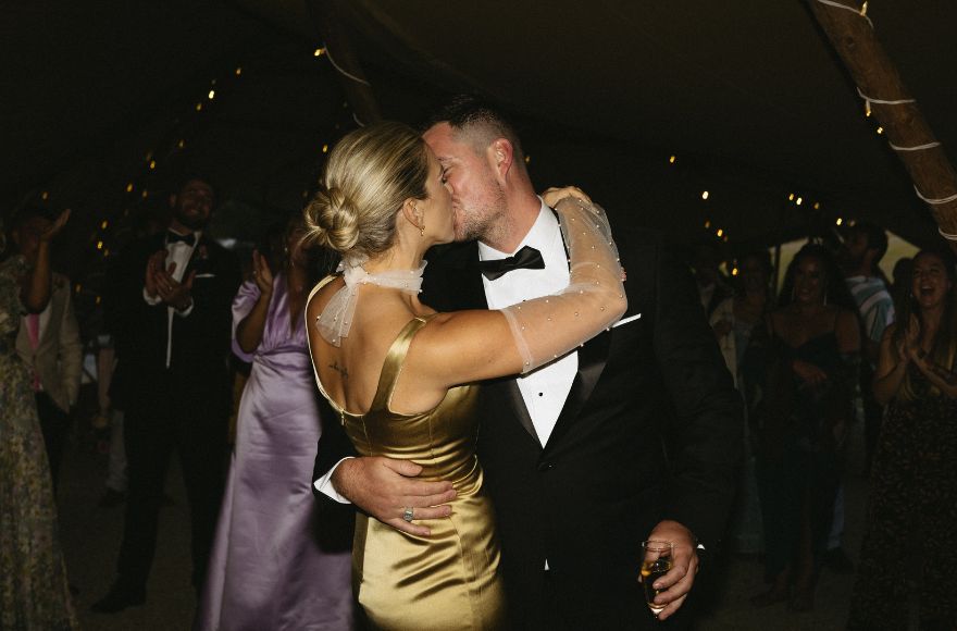 Newlyweds share a kiss on the dancefloor