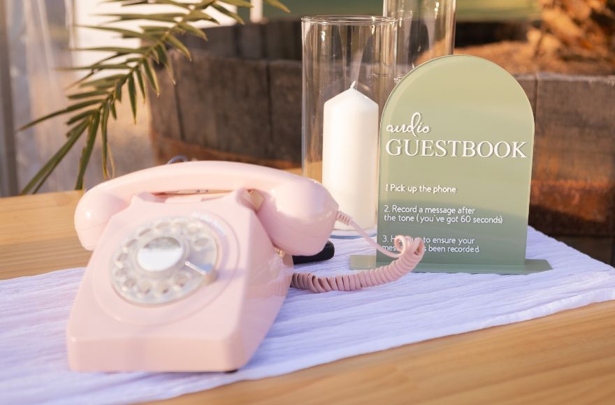 Old fashioned pink rotary phone as a guest book alternative