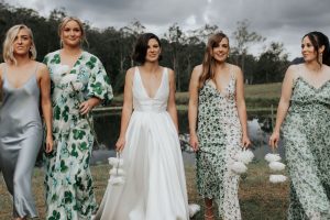 A bride in ivory with her 4 bridesmaids in different dress designs and prints